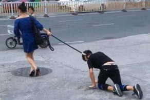 Shocking moment a woman takes her male companion for a walk on a DOG LEASH in China
