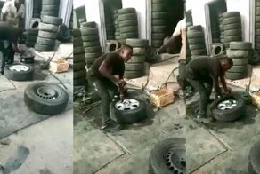 Шиномонтажник мастерски орудует монтировкой