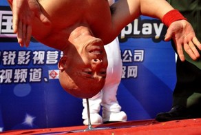 Каскадер Ли Синь из Китая простоял на голове 10 секунд на шипе (3 фото)