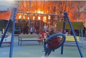 Невозмутимые жители Котласа катаются на качелях на фоне горящего дома