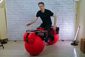 Мотоцикл с большими красными шарами вместо колёс