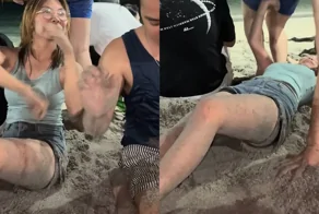 На пляже мужчина случайно сел на лицо девушке