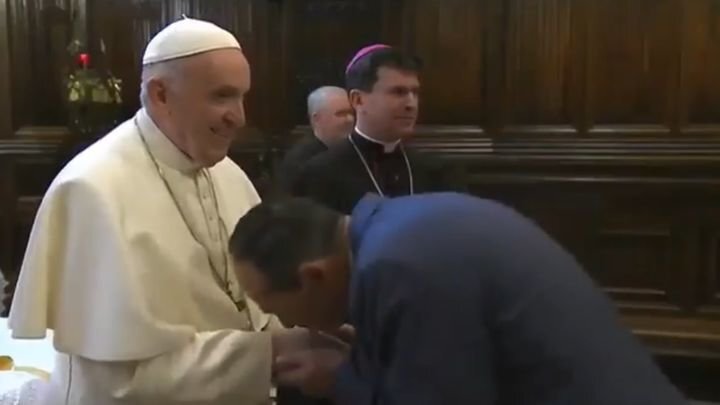 Папа Римский выдергивает руку из-под губ пытающихся поцеловать его перстень верующих 