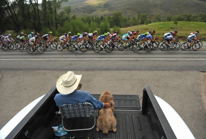 Man watches race in his truck with his dog 