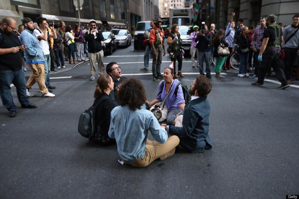 Peaceful protesters sit in the street