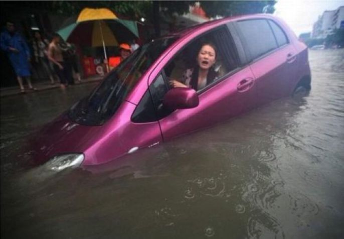 Woman Drives through Flood 