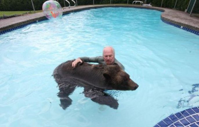 Swimming with his bear 