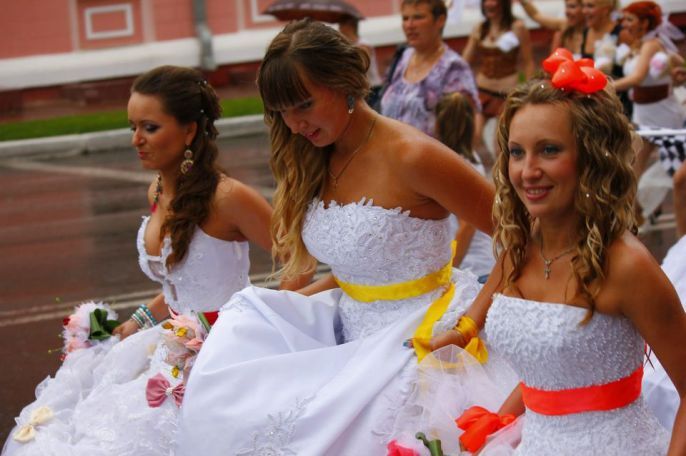 Brides lifting their dresses to walk 