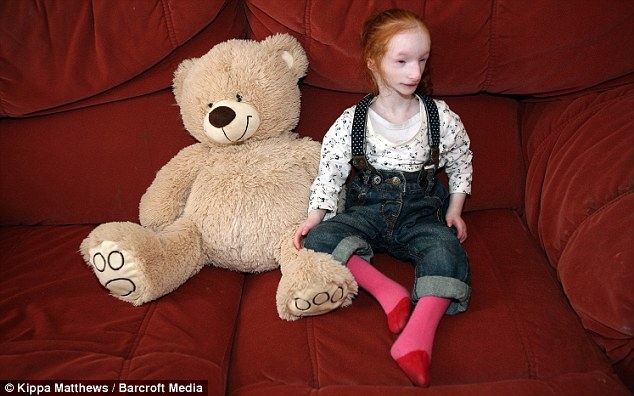 Tiny Girl Next To Teddy Bear 