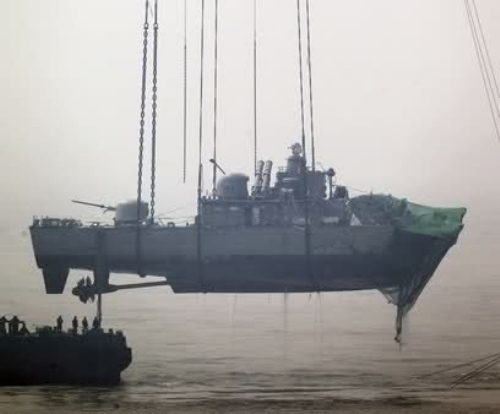 Crane Lifting Navy Vessel 