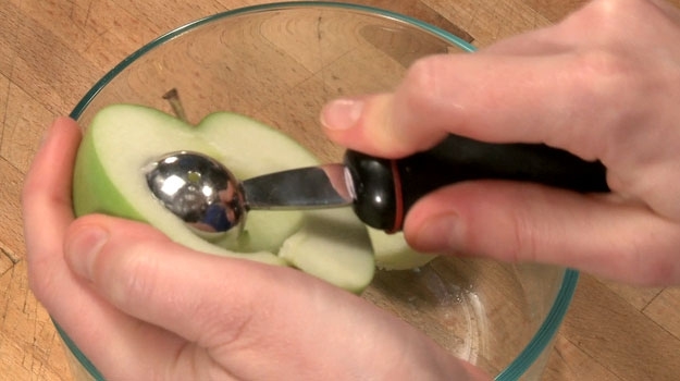 Using a melon baller, scoop out the inside of the apples. This part is the least fun
