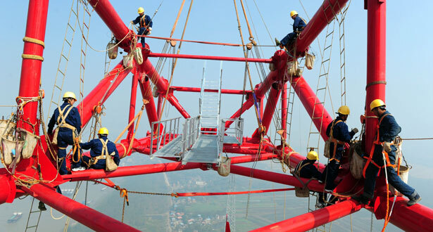 Workers on top of world's tallest pylon 