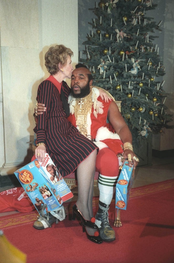 Nancy Reagan sitting on Mr. T’s lap (and kissing his head!)