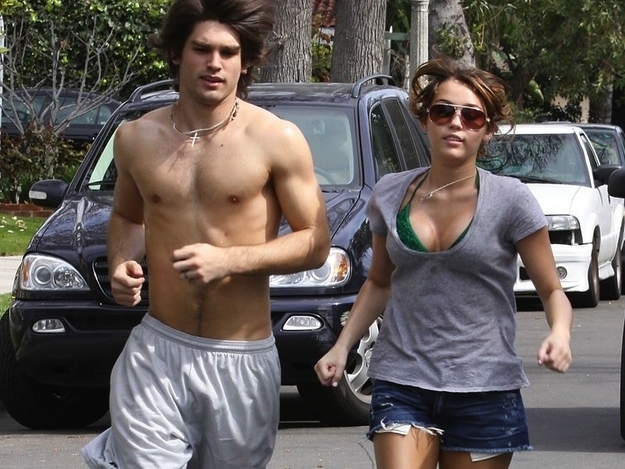 February 2009: Miley jogs without a sports bra 