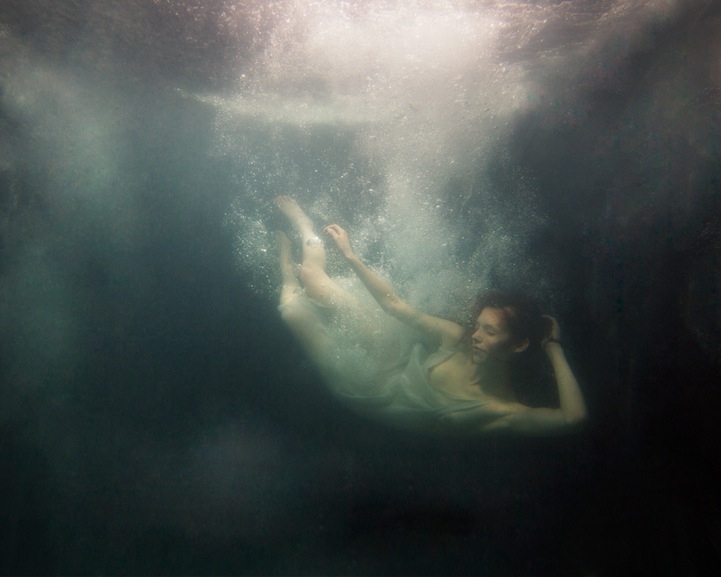 Eerily Floating In a Dark Underwater Abyss 