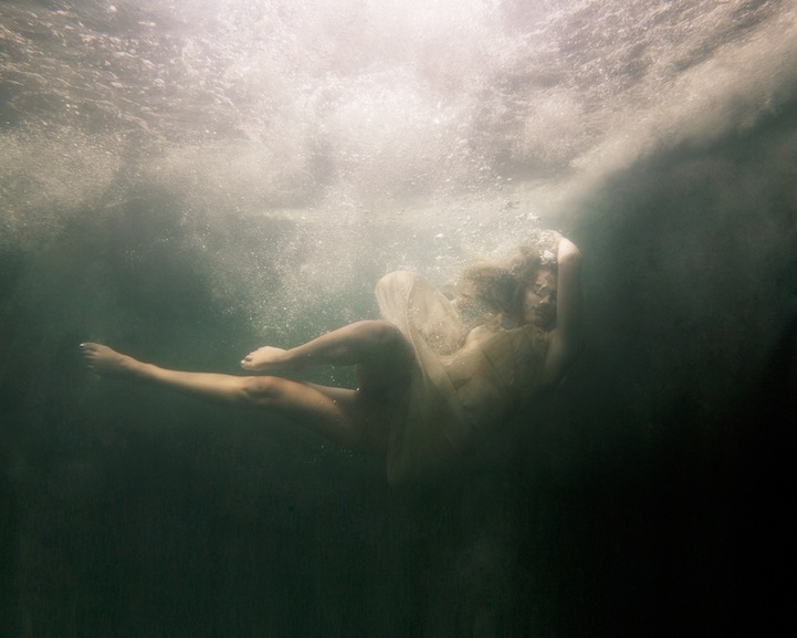 Eerily Floating In a Dark Underwater Abyss 