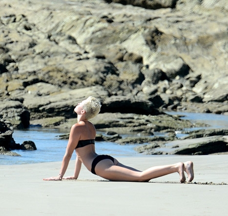 Miley Cyrus Wears Tiny Bikini Doing Yoga Moves on the Beach