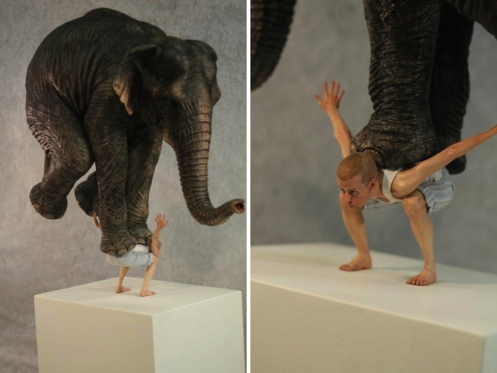 Tiny Man Precariously Balances an Elephant on His Back 