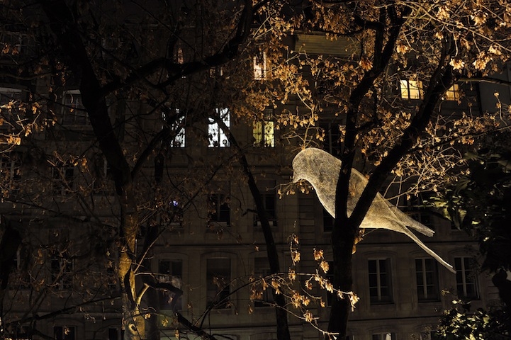 Illuminated Wire Bird Sculptures Perched on Trees