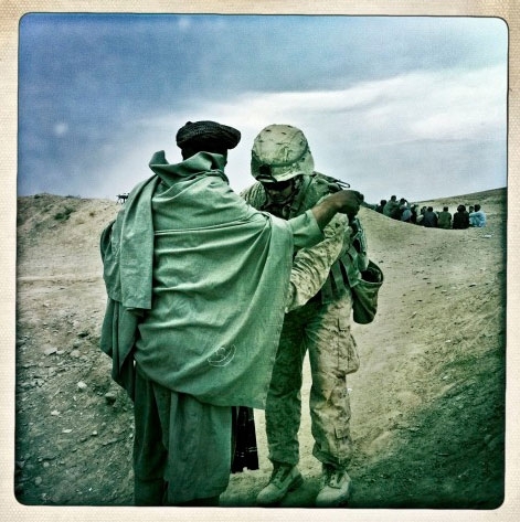 Soldier Pats Down A Civilian 
