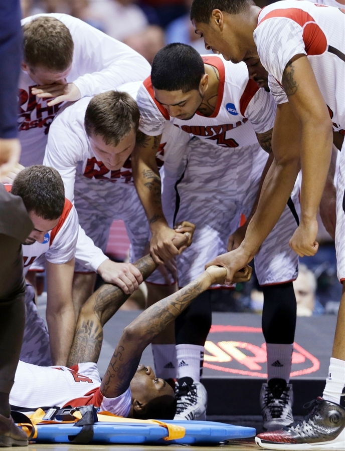 Louisville Cardinals' Players Attend to Kevin Ware