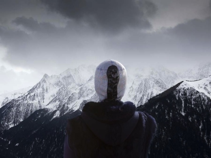 Masked Man Looking At Snow Covered Mountains