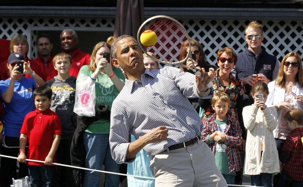 Barack Obama attempting to play tennis 