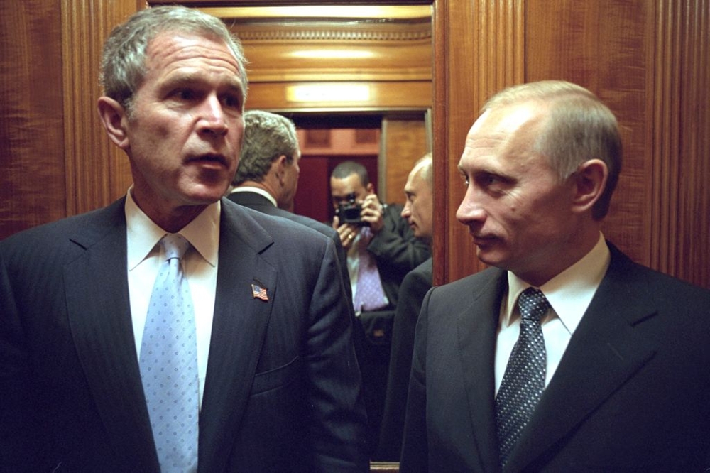 Eric Draper Caught a picture of himself in this photo of Bush and  Russian President Vladimir Putin