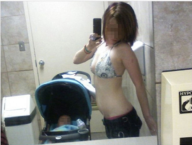 The public restroom in a bikini with a baby selfie.
