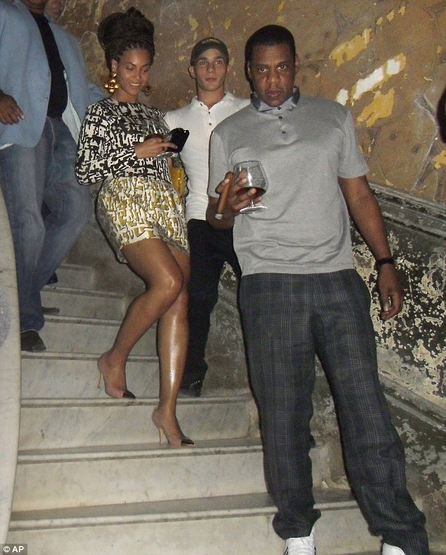 Jay-Z appeared to stare protectively of his wife who carefully stepped behind him in heels as they walked into the flash