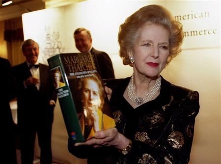 Margaret Thatcher poses with a copy of her new book 