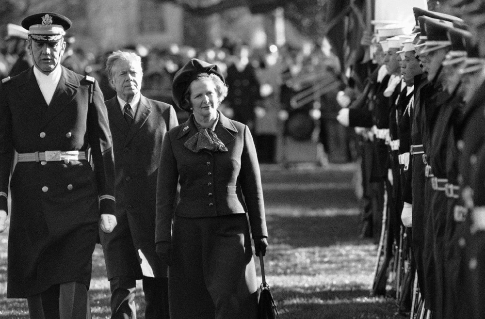 British Prime Minister Margaret Thatcher reviews the honor guard at the White House