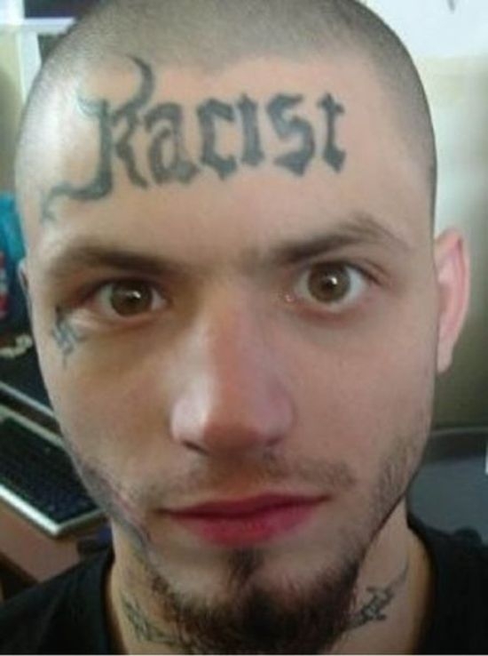 "Racist" tattoo on the forehead