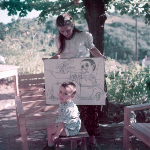 Françoise Gilot, Picasso's lover for 10 years, with their young son, Claude. She holds drawings of the boy by Picasso.