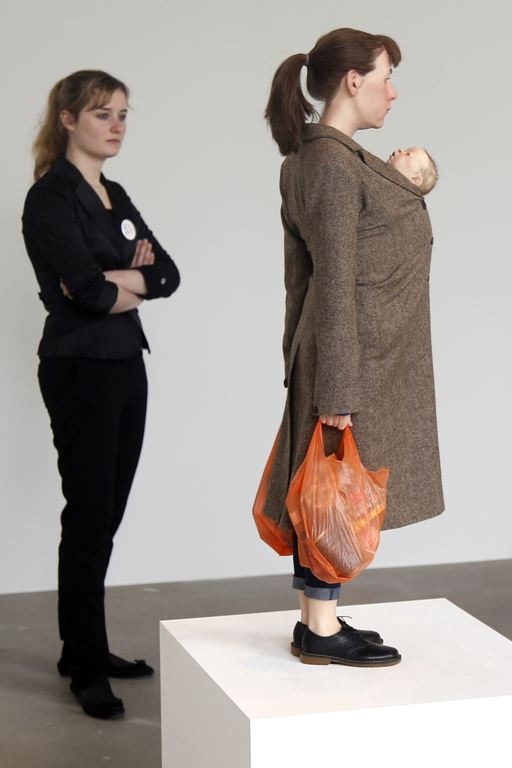 A visitor looks at a sculpture entitled "Woman with Shopping, 2013"