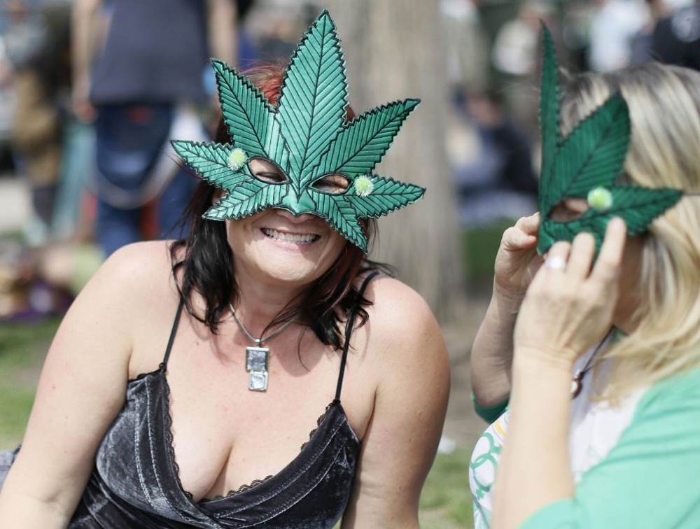 Woman Wearing Marijuana Leaf Masks Smile 