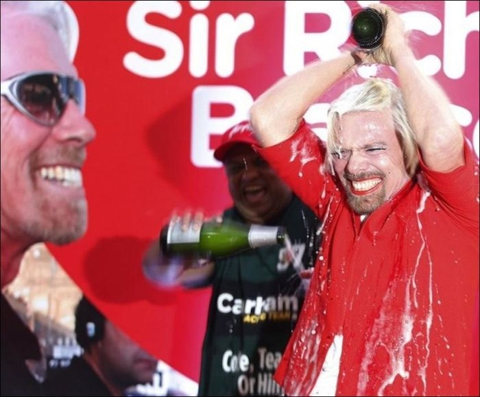 The billionaire was doused in champagne after finally completing his side of the bet