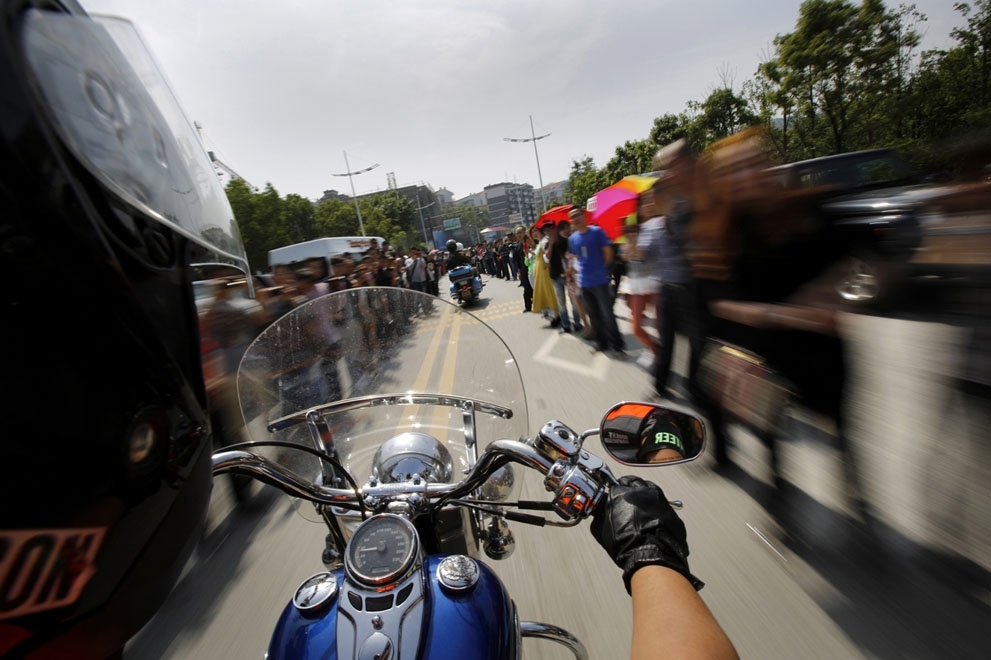 A man rides through a crowd in Zhejiang Province, on May 11, 2013.
