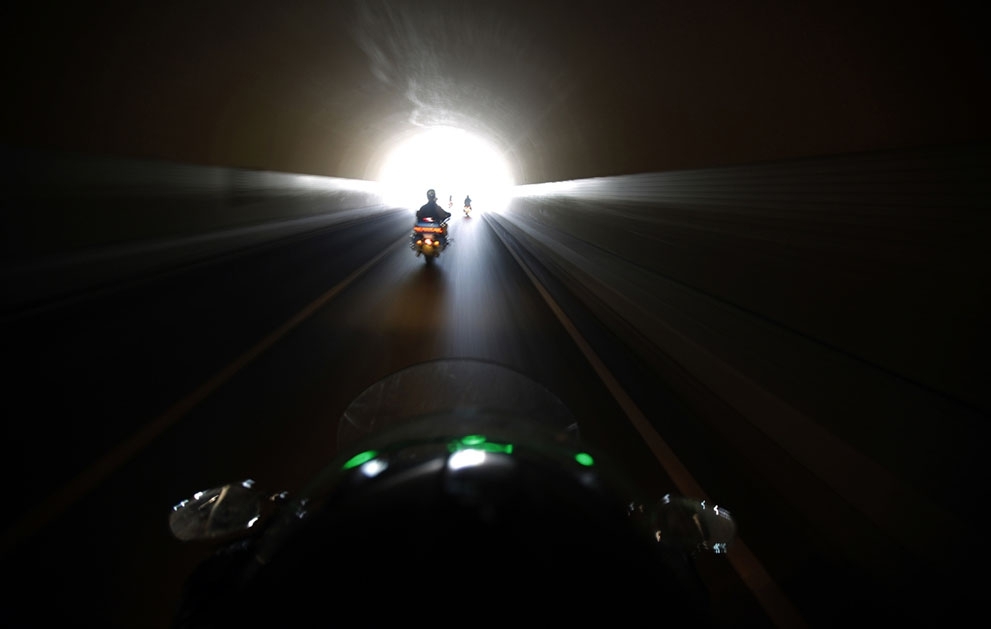 Harley Davidson riders pass through a tunnel during the annual rally in Qian Dao Lake, on May 11, 2013.
