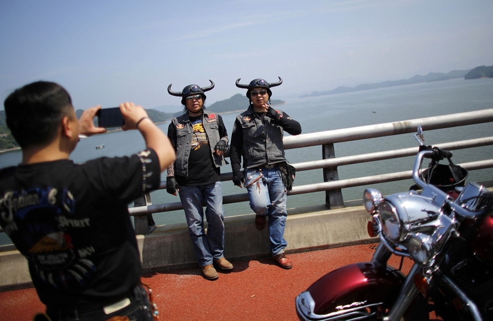 Helmeted riders pose in Qian Dao Lake, on May 11, 2013.