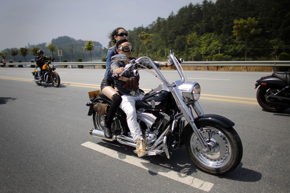A couple rides their motorcycle at the Qian Dao Lake rally, on May 11, 2013. 