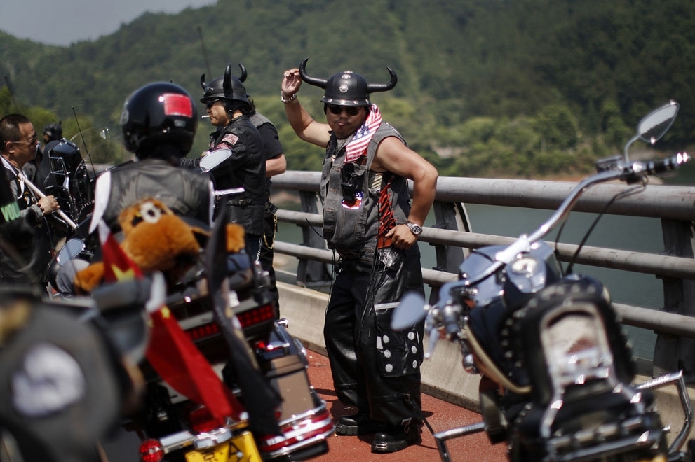 A Harley Davidson fan dances during the annual rally in Qian Dao Lake, on May 11, 2013.