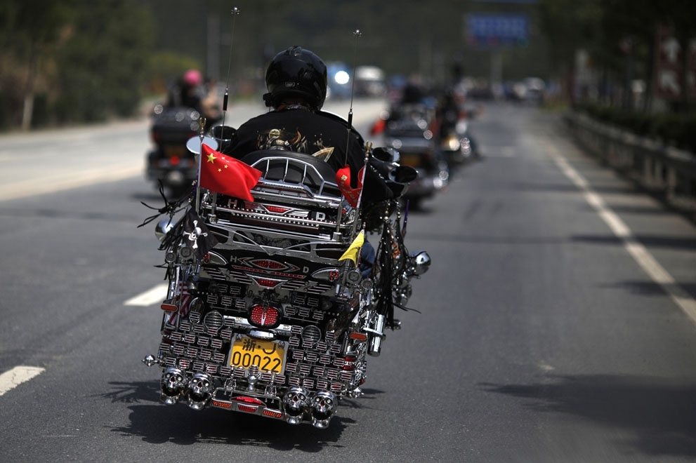 A man rides a decorated Harley Davidson in Qian Dao Lake, on May 11, 2013.