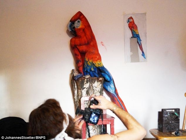 Artist paints woman's entire body to make her look like a parrot