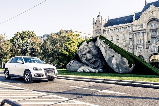 A Giant Sculpture Crawls Out Of The Ground In Budapest