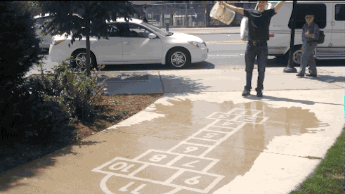 Artist Creates Street Art To Make People Smile On A Rainy Day