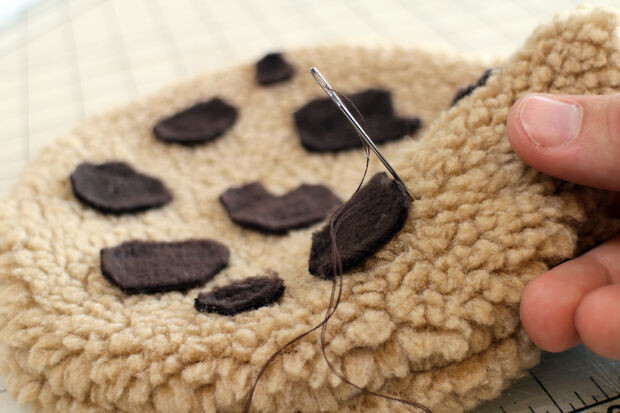 After cutting out the cookie shapes, he sewed the halves together and attached chocolate chips. Then he stuffed the cookies with pillow batting.
