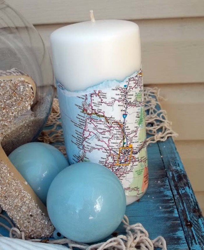 Cover a candle with a map and seal it with Mod Podge.
