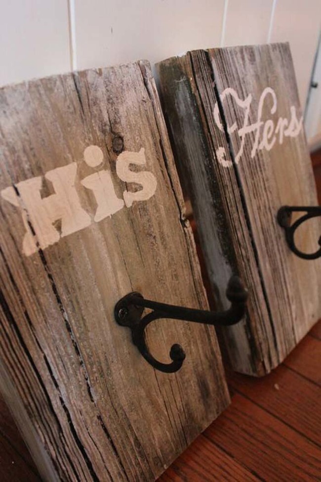 Attach hooks to planks of reclaimed wood to make bathroom towel holders.