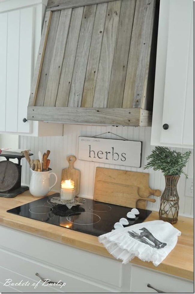 Cover a kitchen vent in reclaimed wood to give the room a rustic vibe.